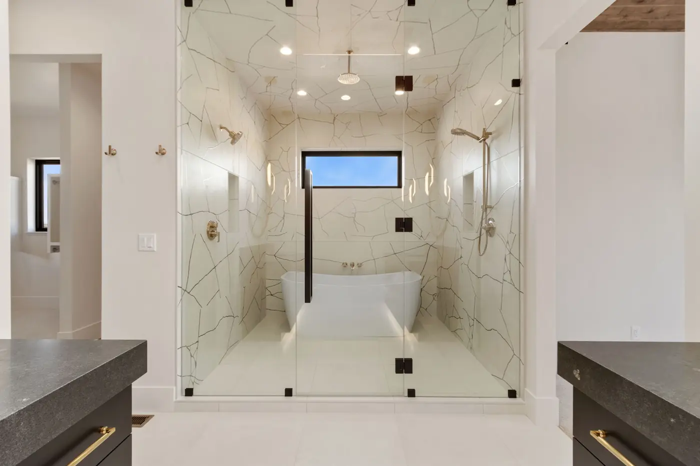 Primary bathroom with a freestanding tub and double shower